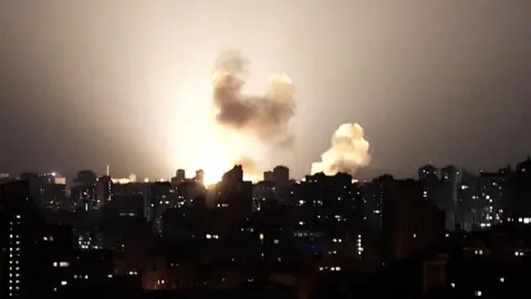 Ukraine skyline at night lit up by a missile