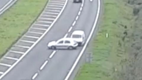 A white van ramming into the side of a car on a dual carriageway