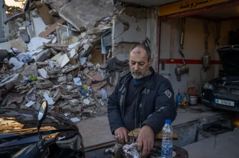 Imad Abdelhak's car garage was damaged by a direct strike on the adjacent building