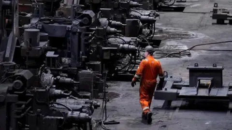 Reuters Steelworker wearing protective clothing and a hard hat