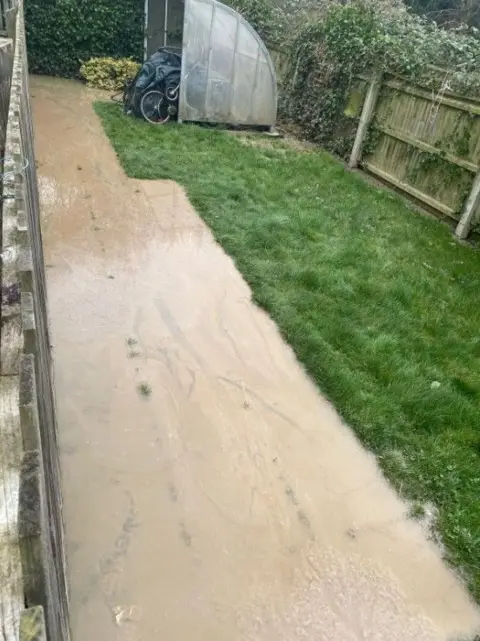 Sarah Cargill A path near a bicycle store which has been flooded with raw sewage