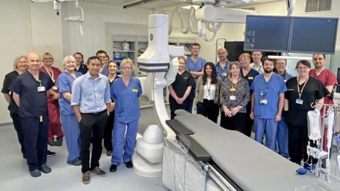 The team in the new cath lab for cardiology patients at the RUH standing in a group by their new equipment