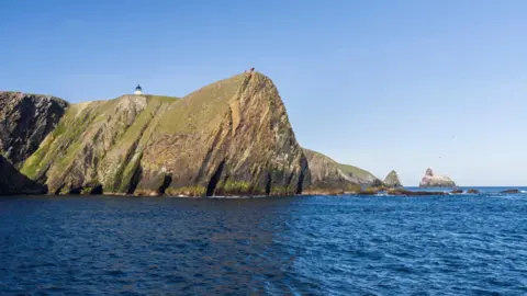 Getty Images A sheer cliff on part of Fair Isle's rocky coast.