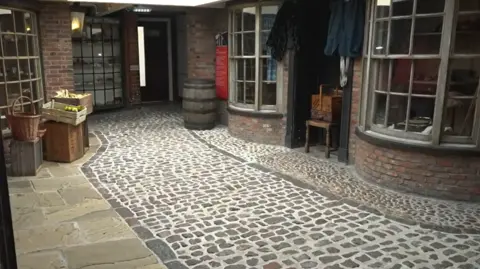cobbled street and shop windows in Museum 