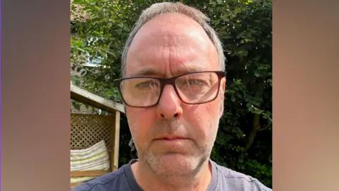 Supplied A man in glasses. 