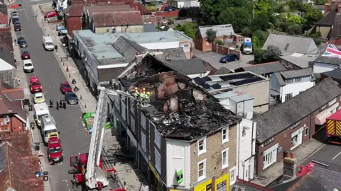 Aerial view of terrace in Petersfield town centre the roof across the terrace is burnt out.