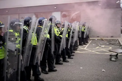 Getty Images Riot police outside a Holiday Inn near Rotherham housing asylum seekers that was targeted during the disorder