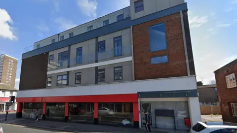 Google The building on Southchurch Road in Southend-on-Sea. It is four storeys high and there is brickwork and cladding visible. There appears to be a vacant commercial unit on the ground floor.