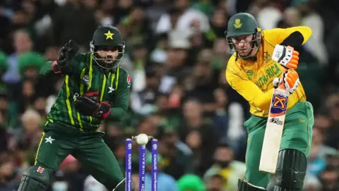 Mohammad Rizwan of Pakistan watches on as South Africa's Heinrich Klaasen plays a shot