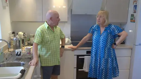 Karen and Tony stood in their kitchen