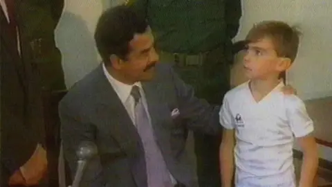 Stuart Lockwood poses with Saddam Hussein