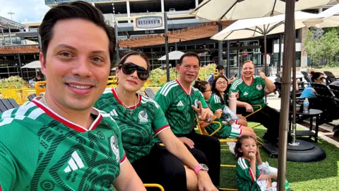 Sergio Enrique Alvarado Montalvo takes a selfie with his family as everyone sports a Mexico jersey.
