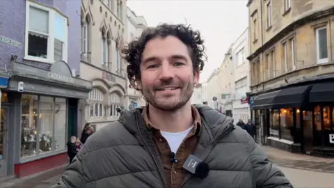Close-up of journalist Charlie Taylor in the streets of Wells, Somerset