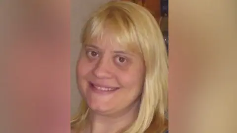 Surrey Police A picture of a woman with blonde hair.