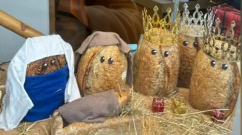 Loaves of bread dressed up as the nativity scene outside a bakery in Nailsworth in Gloucestershire