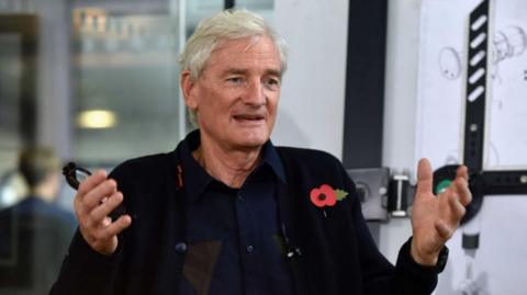 Sir James Dyson wearing a black shirt with a poppy.