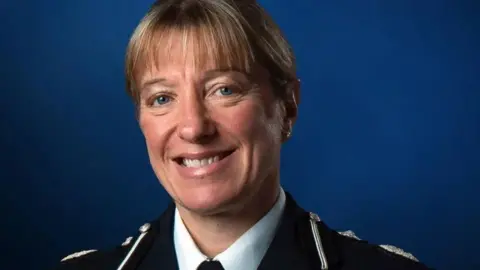 Chief Constable of Sussex Police Jo Shiner in police uniform in front of a dark blue background