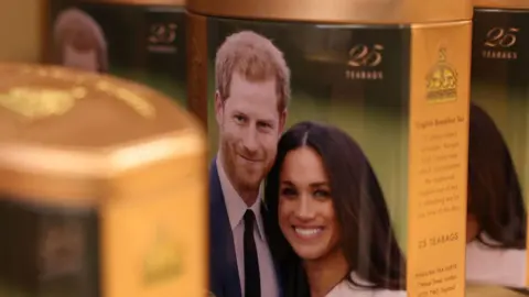 Getty Images A souvenir tin featuring an image of the Duke of Sussex and the Duchess of Sussex