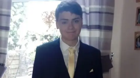 Family photo Family photo of Ben Leonard standing in a suit and tie