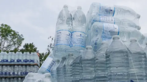 Bottles of water in a pile.