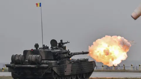 Getty Images Tanks fire during NATO exercises in Romania