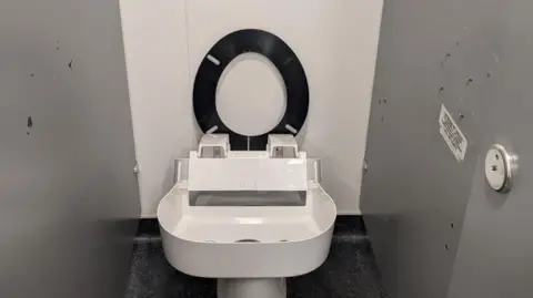 East Suffolk Council A toilet in a public facility is missing the seat