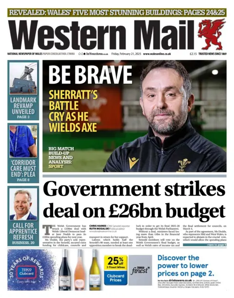 Western Mail Front page of the Western Mail, where an image of Matt Sherratt is in the centre next to the headline: Be brave, Sherratt's battle cry as he wields axe. The image sits above the main headline: Government strikes deal of £26bn budget. 
Other headlines on the front page include: Call for apprentice refresh. 'Corridor care must end': plea. Landmark Revamp unveiled. 