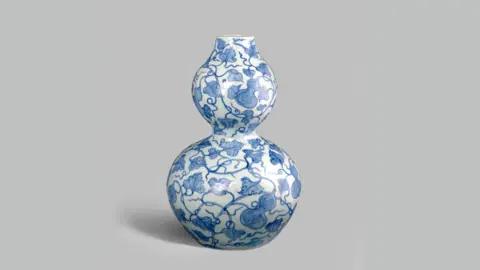 Woolley & Wallis A Chinese vase from the Yuan Dynasty with blue plant motifs against a white background.