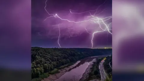 Matthew Harris Lightning fills a purple sky over the River Avon in Bristol