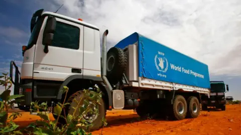 A white-and-blue truck eblazoned with the logo of the UN's World Food Programme agency