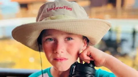 Alfie Kiely Alfie wearing a Lord of the Flies branded sun hat