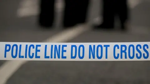 Police tape on an empty street - this is a stock image