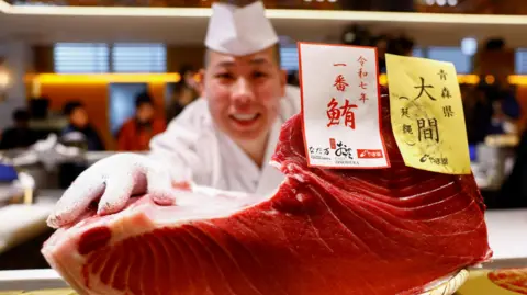 Reuters A sushi chef shows off a fillet from a 276-kilogram bluefin tuna