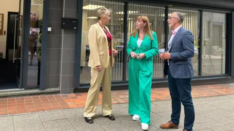 BBC Council leader Jane Ashworth, Angela Rayner MP and Lloyd Cooke, chief executive of Saltbox stand on a street in Hanley after a meeting 