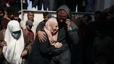 Getty Images Relatives of the 9 Palestinians, including 3 journalists, who died as a result of Israeli airstrikes on the Beit Lahia, mourn as the dead bodies brought to the Indonesian Hospital in Beit Lahia, Gaza on March 15, 2025. 