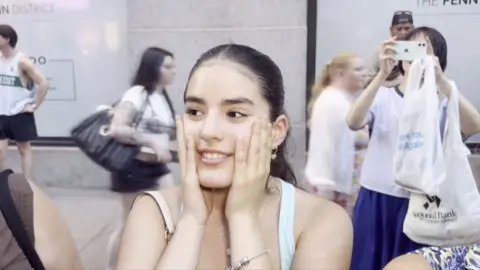 A girl is reacting to wedding announcement.