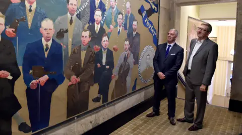 Trinity Mirror Paul Flanagan and Len McCluskey at the unveiling of an artwork in Liverpool in 2014. The paintings, by artist David Jacques, depict the working class struggle of the 20th century.