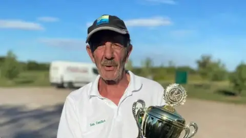 Lake Snakes Angling Club Ian Coates holding a trophy