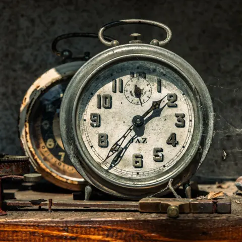 Carsten Schnoor An alarm clock covered in a spiders web