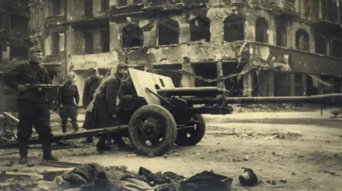 Reuters A Soviet artillery piece and Russian soldiers on the streets of Berlin in 1945