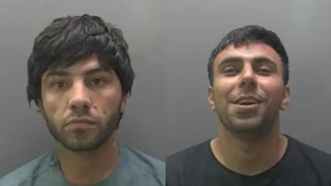 Custody image of Torgalai Estoman (left) with a straight face, wearing a grey T-Shirt and Gulzaman Safizada wearing a black T-shirt - laughing