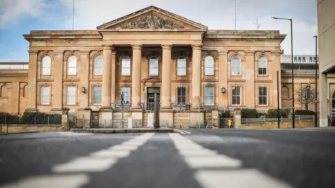 BBC The exterior of a court building taken from ground level. The street is visible in the foreground.