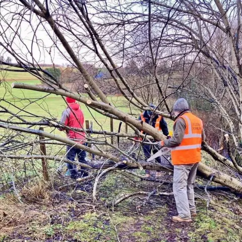 Pitlochry Path Group  volunteers at felled tree