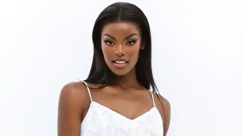 Miss SA organisation An image of Chidimma Adetshina wearing a white dress in front of a white background