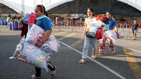 AFP via Getty Images Residents taking refuge in a temporary shelter in Buriram Province, following clashes between Thai and Cambodian soldiers that have heightened tension along the border.