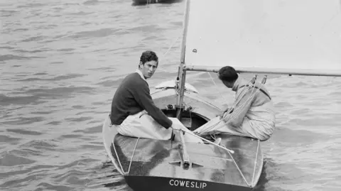 Getty Images Prince Charles at the helm of his 20ft Flying Fifteen yacht 'Coweslip', in a handicap race off the Isle of Wight during the Cowes Week regatta, 3rd August 1971. 