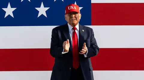 US President Donald Trump claps as he arrives to speak at the Salute to America Celebration at the Iowa State Fairgrounds in Des Moines on 3 July, 2025. 