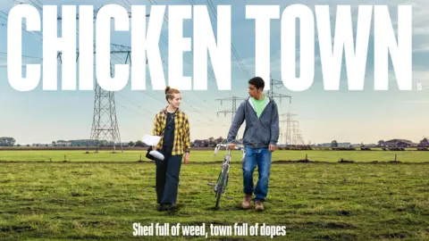 Two people walking through a flat field to represent the Fens in East Anglia. They are looking at each other. One is pushing a bike. They are both wearing casual clothes. There are pylons in the background. It is the poster for a film. The title says: Chicken Town, shed full of weed, town full of dopes. 