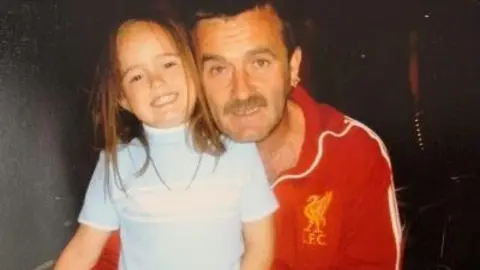 A young Ellie Harris with her dad 
