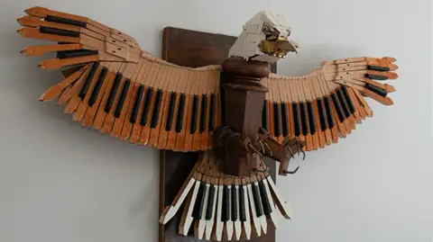 Marc Hackworthy An eagle made from piano keys hanging on a wall
